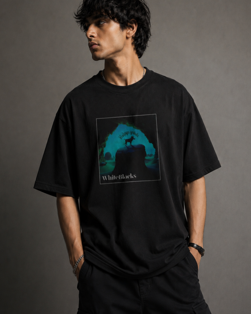 A man wearing a black oversized t-shirt with a square graphic print on the chest. The graphic features a dark silhouette of a dog on a rock with teal and blue background lighting and the text 'White-Locks' at the bottom.